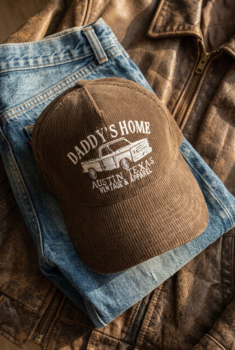 Brown embroidered Daddy's Home corduroy hat flat lay