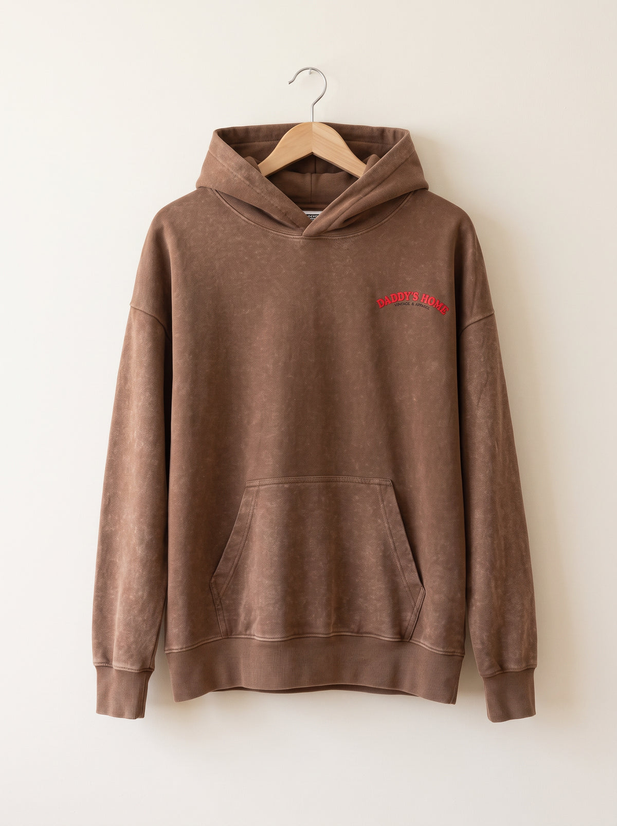 The Oversized Martini Logo Sweatshirt, front view on a plain off-white wall