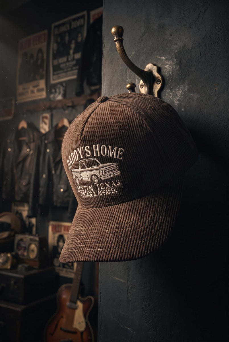 Brown Daddy's Home hat with full corduroy crown hanging on hook