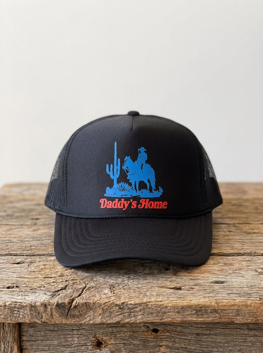 Daddy's Home Classic Cowboy Black Foam Trucker, front view on a rustic wooden table