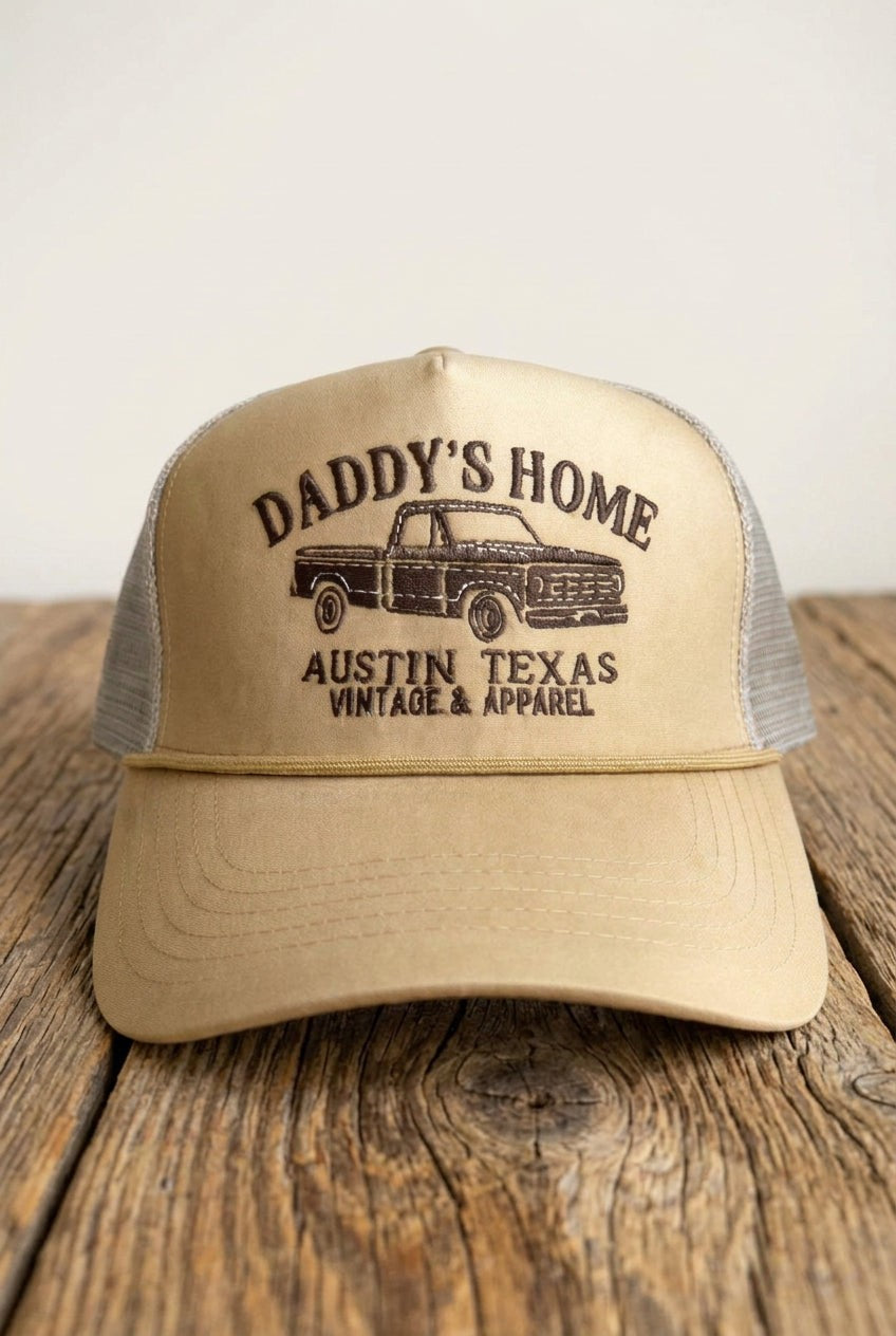 DADDY'S HOME Embroidered Tan Trucker on a rustic wooden table
